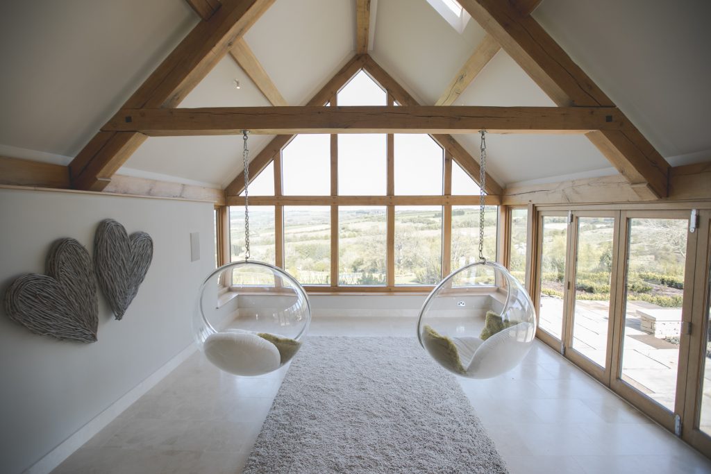 Sustainable wooden attic with roof hanging chairs